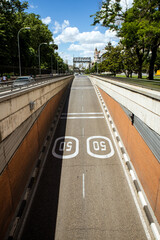 Route, highway, road, way to the tunnel entrance. Top view of empty paved road with marking signs for 50 km per hour traffic restriction. Urban infrastructure, cityscape vertical background. Madrid.