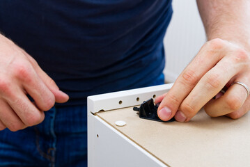 Professional Furniture Assembly Worker Assembles Shelf. Furniture assembly process. Assembling several pieces of furniture. DIY Assembling