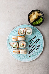 Overhead view of fish sushi with avocado and cream cheese