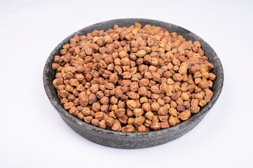 chickpeas (Bengal Gram) in rock bowl on white background. Close up of Organic chana or chickpea (Cicer arietinum). for design and banner. top view chickpeas.