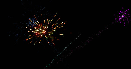 Image of colourful christmas and new year fireworks exploding in night sky