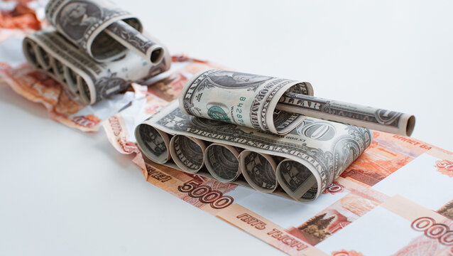 tank made of dollar bills rides on a road made of ruble bills.