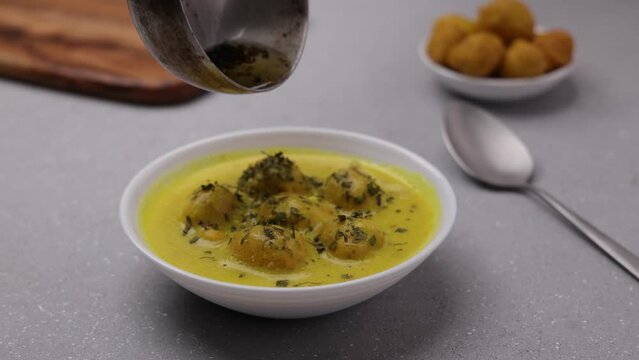 Kadi Pakoda served in a a white shallow plate