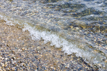 Little wave on rock shore