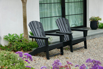 pair of matching black outdoor cheap Adirondack chairs on the terrace