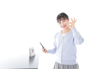 Young woman paying with digital money