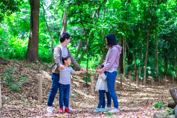 Family playing in the forest