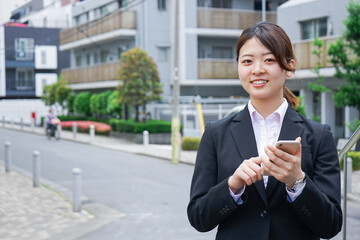 Young businesswoman searching for a destination with her smartphone 