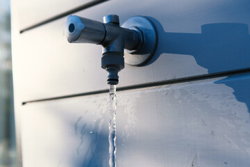 Water runs out of the garden faucet.