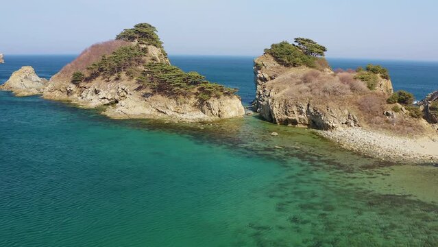 Aerial view of a rocky promontory with a strait between the rocks. Beautiful bay Orlinka (Warm) with clean and clear water. Marine reserve. Untouched nature.