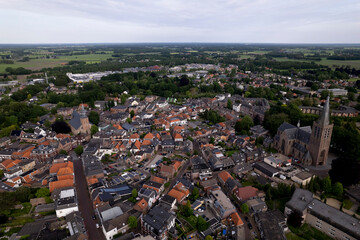 Skyline with rooftops of city center Dutch town Groenlo. Aerial picturesque painterly village on overcast day.