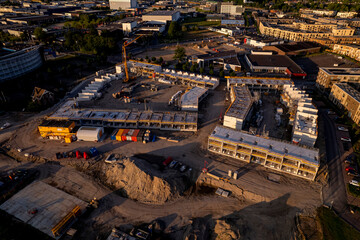 Sunset aerial view of real estate project PUUR21 new housing construction site part of urban development plan Noorderhaven neighbourhood with blueprint outline visible intermediate building phase