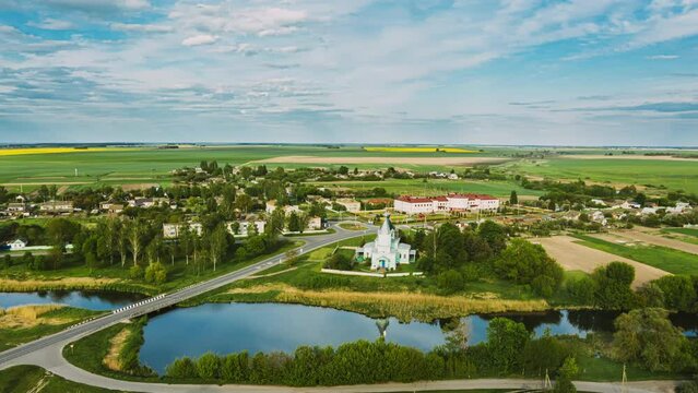 Krupets, Dobrush District, Gomel Region, Belarus. Aerial View Of Old Wooden Orthodox Church Of The Holy Trinity At Sunny Summer Evening. Drone Hyper lapse. 4K.