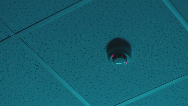 Fire Detection Sensor hangs on roof inside parking or office near ventilation system . Fire and safety equipment, emergency detector under the roof . Hanging Fire Detection Sensor