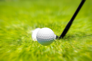 Closeup of hitting golf ball with golf iron club golf course wih motion blur effect