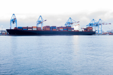Naklejka premium Cargo container ship in import export business logistic ,port of Genova, Italy