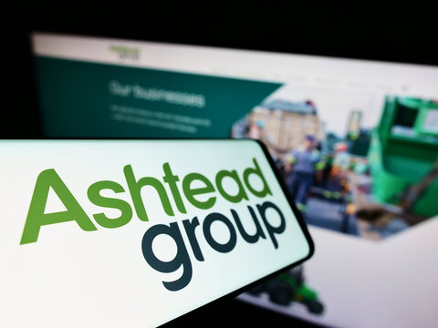 Stuttgart, Germany - 05-29-2022: Smartphone with logo of equipment rental company Ashtead Group plc on screen in front of business website. Focus on left of phone display.