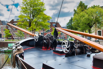 The bow of a traditional Dutch sailing barge, with anchor winch and mast winch, in the harbour of...