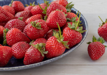 Red fresh strawberries on the plate kitchen table
