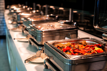 Breakfast and lunch buffet food catering banquet in hotel. Heated buffet container with meat and...