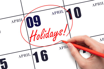 Hand drawing a red circle and writing the text Holidays on the calendar date 9 April. Important...
