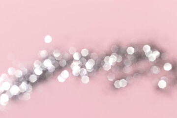 Sparkling silver glitter on pink background. Holiday blurred lights