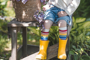 Happy childhood. Close-up view of a little boy's feet with socks with a rainbow LGBT flag. Pride...