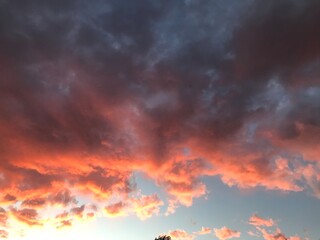 Beautiful sunset sky above the clouds with dramatic light. Heaven is a ray of light from the sun behind a cloud in the blue sky.