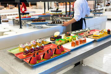 Photo of a sweet table for the holiday pastries and cakes in the hotel bar with staff