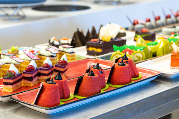 Beautiful and bright photo of pastries and cakes on the bar counter in the hotel