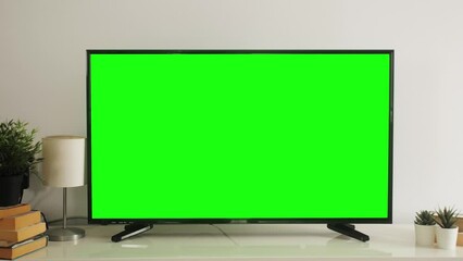 LSD smart TV screen with a blank green background in the living room. Chroma key screen for advertising.