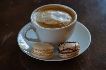 Coffee cup with macaroons meringue cookies chocolate