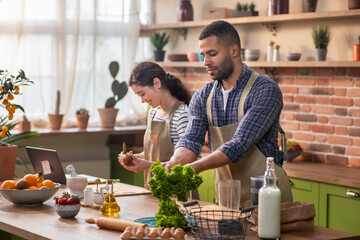 Healthy food at home. Happy loving couple is preparing the proper meal in the kitchen.