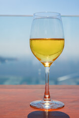 The glass of white wine outdoors.