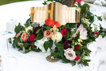 Bouquet of flowers in vase and a plate for the table number