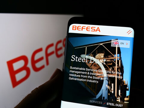 Stuttgart, Germany - 05-21-2022: Person holding cellphone with webpage of recycling company Befesa SA on screen in front of business logo. Focus on center of phone display.