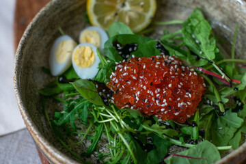 salad with red caviar and quail eggs serving food
