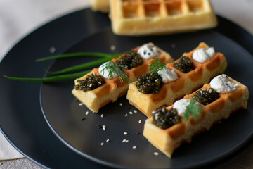 black caviar on a waffle serving on the table