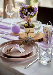 Table setting with sparkling wineglasses, plate and cutlery on table, copy space. Place set at wedding reception. Table served for wedding banquet in restaurant