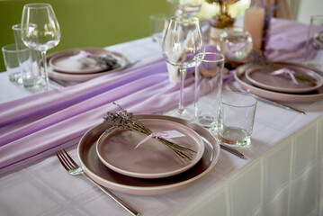 Table setting with sparkling wineglasses, plate and cutlery on table, copy space. Place set at...