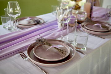 Table setting with sparkling wineglasses, plate and cutlery on table, copy space. Place set at wedding reception. Table served for wedding banquet in restaurant