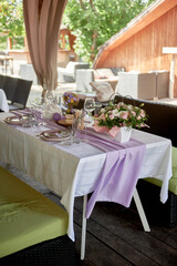 Table setting with sparkling wineglasses, plate and cutlery on table, copy space. Place set at wedding reception. Table served for wedding banquet in restaurant