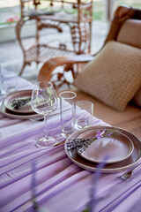 Table setting with sparkling wineglasses, plate and cutlery on table, copy space. Place set at wedding reception. Table served for wedding banquet in restaurant