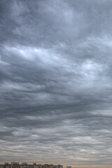 Cloudy sky over the city. Big city. Buildings on the horizon. Beautiful clouds. The mood of nature. Gloomy weather.