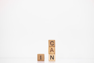 I can word is written on wooden cubes on a white background. Closeup of wooden elements