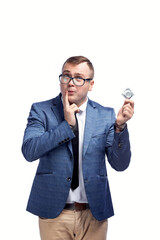 Young guy in a jacket, bow tie, glasses holds a condom in his hand. Isolated on white background