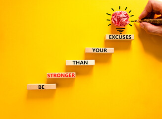 Be stronger symbol. Concept words Be stronger than your excuses on wooden blocks on a beautiful...