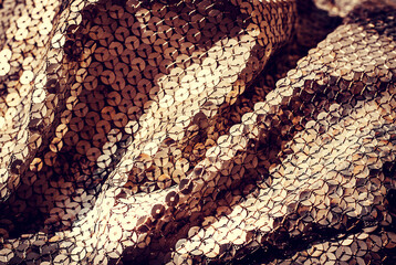 Sequins pattern in bright colors. Multicolored glitter background. Fabric texture with spangles. Background sequin. Glitter texture. Fabric sequins. Iron cloth. Abstract background. Metal structure.