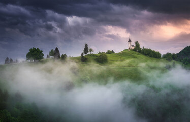 Jamnik church on top of the hill on a moody and stormy day after the rain. - obrazy, fototapety, plakaty
