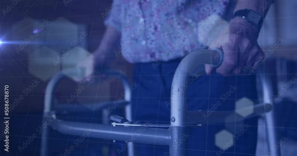 Poster hexagonal shapes over grid network against mid section of senior person using walking frame